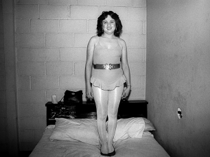 Woman standing on bed by Scot Sothern
