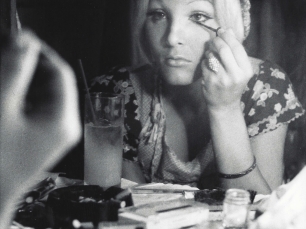 Woman applying make up by Anthony Friedkin